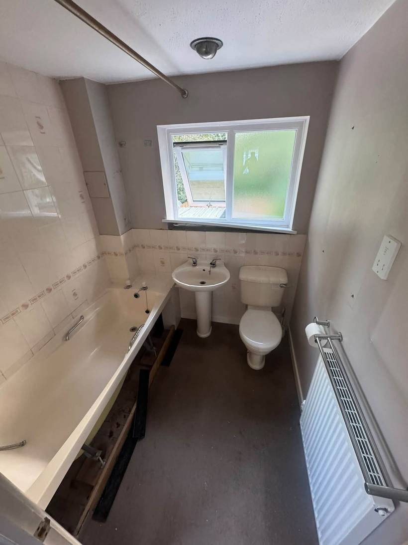 Before: Bath replaced with a walk-in shower and vanity