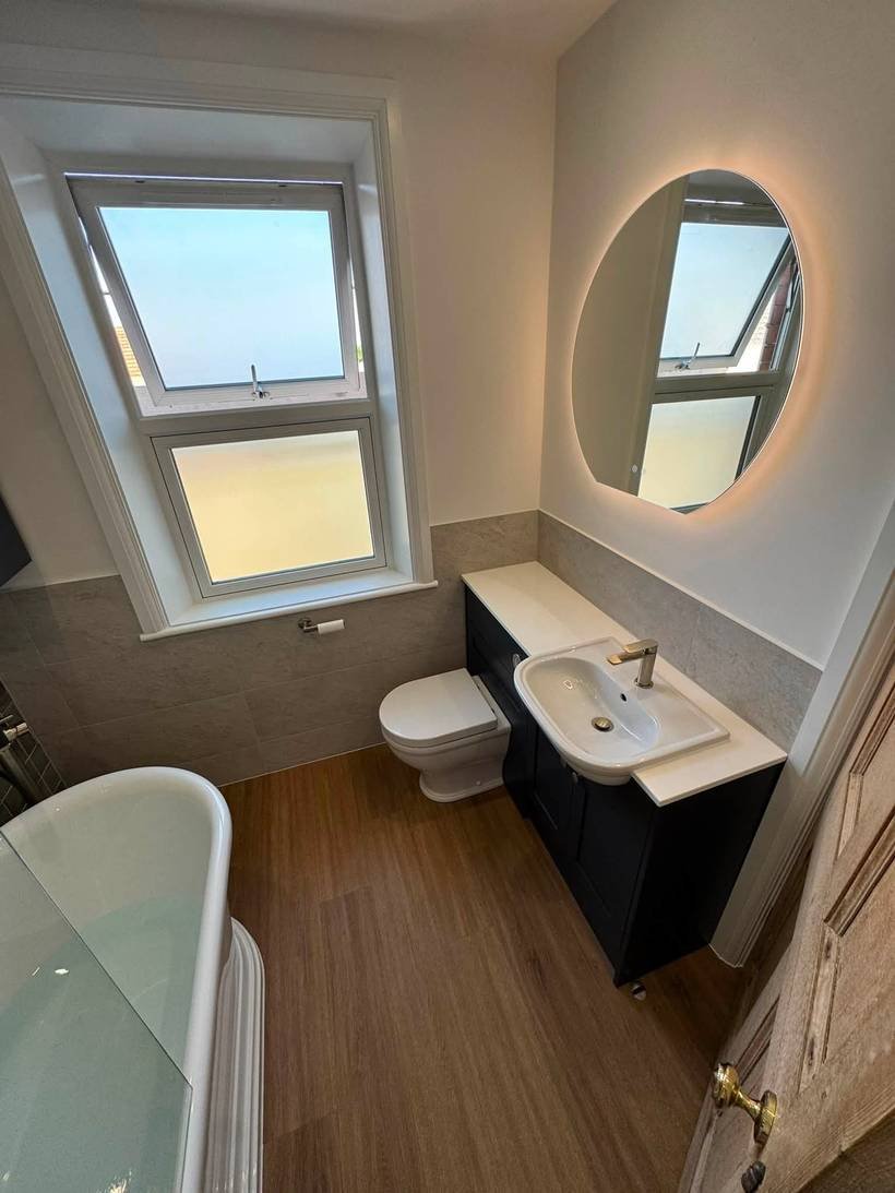 After: Dated bathroom to a backlit mirror and freestanding bath, Aquafix Services Leeds