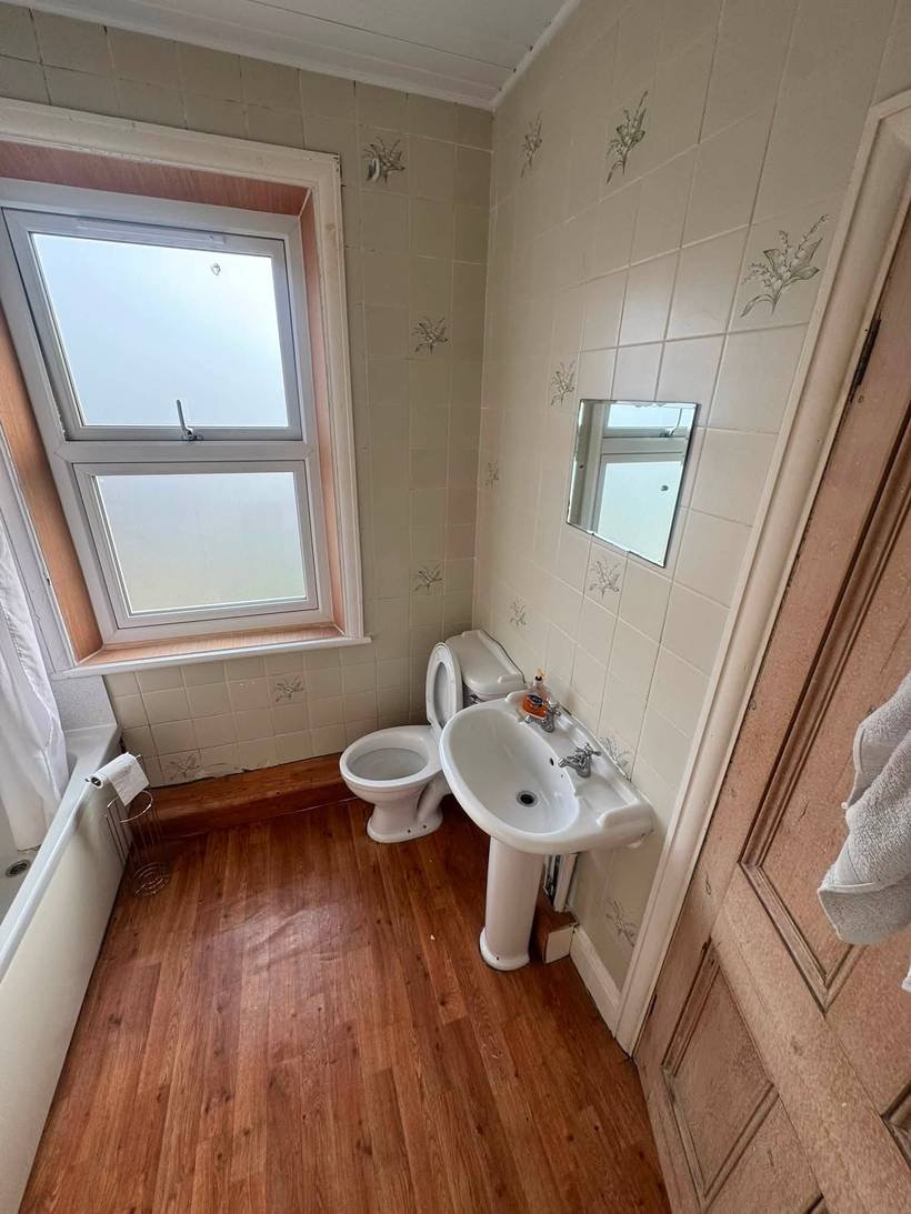 Before: Dated bathroom to a backlit mirror and freestanding bath