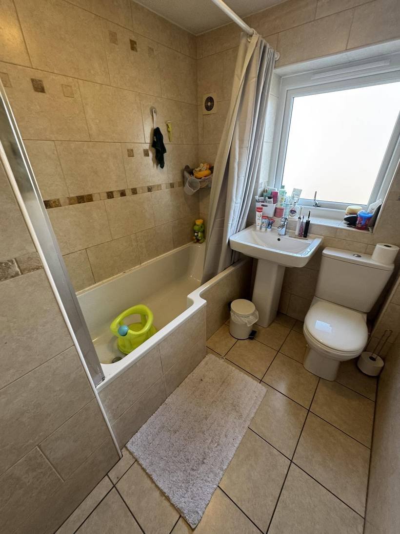 Before: Family bathroom to wall-mounted taps and a curved bath