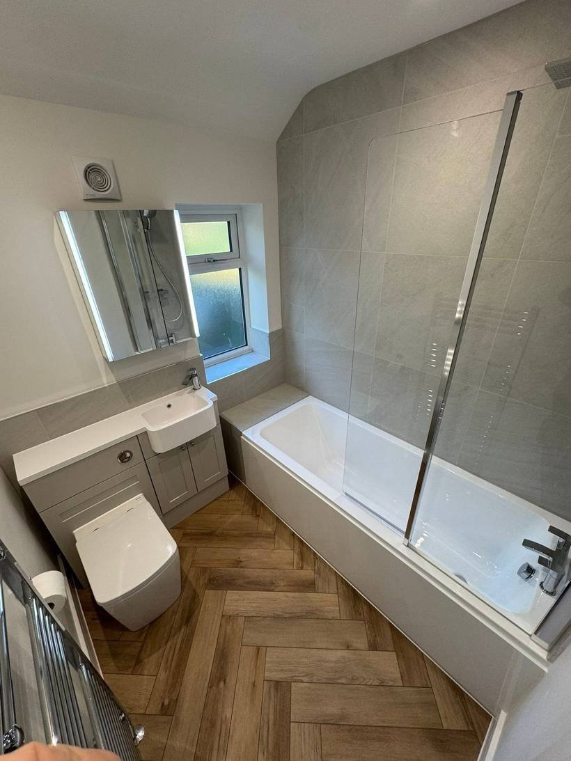 After: Mosaic tiled bathroom to herringbone floor and shower bath, Aquafix Services Leeds